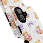 Two sizes of phone cases with cute teddy bear and pastel bow pattern on white background