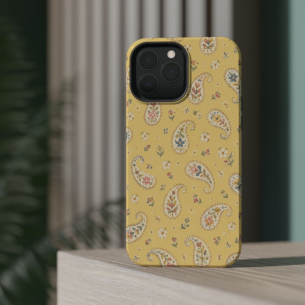 Honey Paisley MagSafe Phone Case, glossy square triple-camera Pro model, rear view on a tabletop