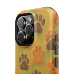 Close-up of iPhone case with brown and orange paw print pattern showing camera cutout and side buttons