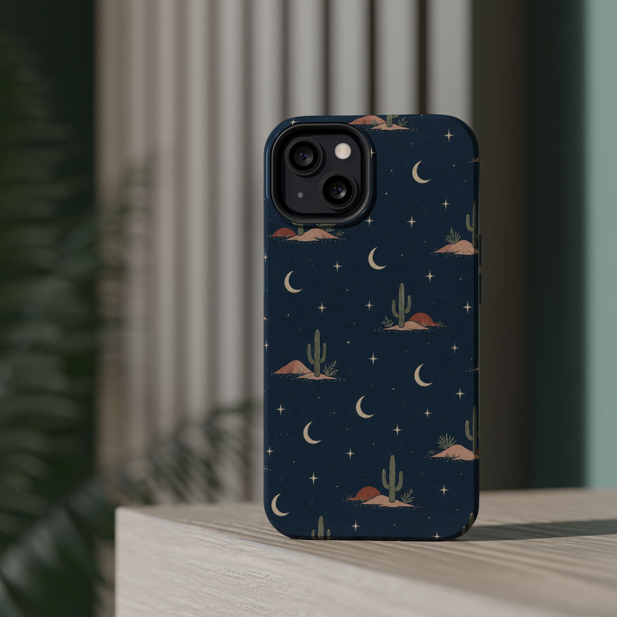 Desert Moon MagSafe Phone Case, glossy diagonal dual-camera model, rear view on a tabletop