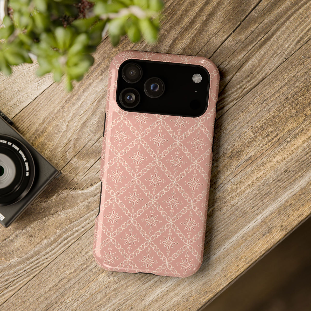 Meadow Lace – Blush Pink Lace Pattern MagSafe Phone Case, glossy wide-camera Pro Max model, rear view on a wooden surface