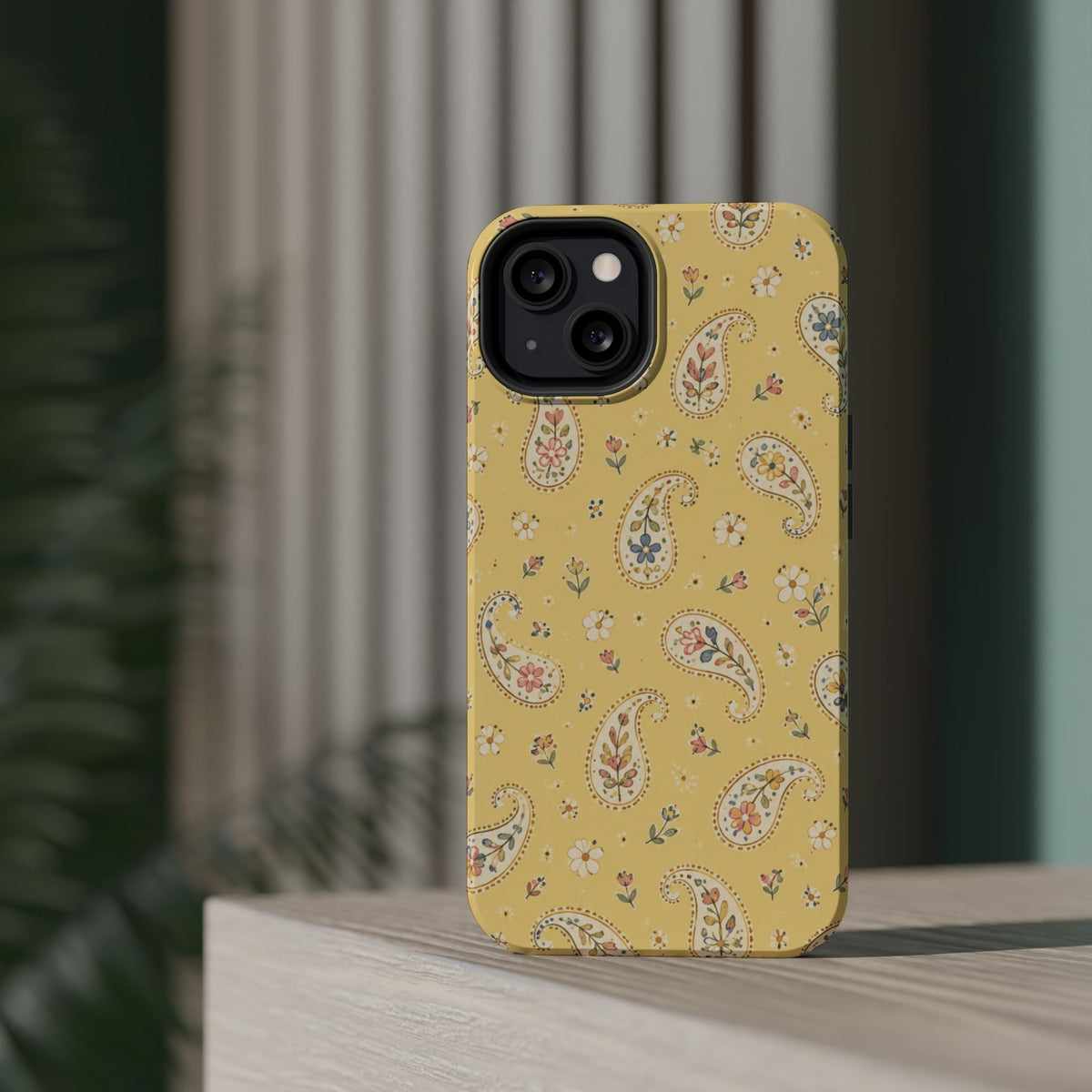 Honey Paisley MagSafe Phone Case, glossy diagonal dual-camera model, rear view on a tabletop