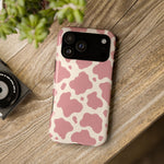 Rose Cowprint – Pink Cow Print MagSafe Phone Case, glossy wide-camera Pro Max model, rear view on a wooden surface