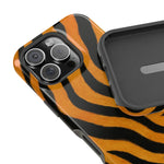 Close-up of iPhone with tiger striped case and separate protective case showing size variant