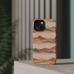 Sunset Trails – Desert Landscape MagSafe Phone Case, glossy diagonal dual-camera model, rear view on a tabletop