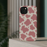 Rose Cowprint – Pink Cow Print MagSafe Phone Case, glossy diagonal dual-camera model, rear view on a tabletop