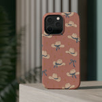 Ribbon Rodeo – Cowgirl Hat and Bow MagSafe Phone Case, Pink, glossy square triple-camera Pro model, rear view on a tabletop