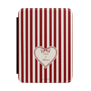 E-reader cover with red and white stripes and a cream heart with a bow and names