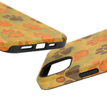 Two sizes of yellow phone cases with orange and brown paw print pattern and black button and camera cutouts