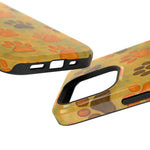 Two sizes of glossy phone cases with orange and brown paw print pattern on yellow background