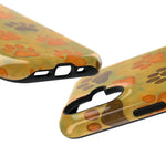 Two glossy phone cases with orange and brown paw print design showing different cutout sizes