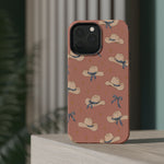 Ribbon Rodeo – Cowgirl Hat and Bow MagSafe Phone Case, Pink, glossy square triple-camera Pro model, rear view on a tabletop