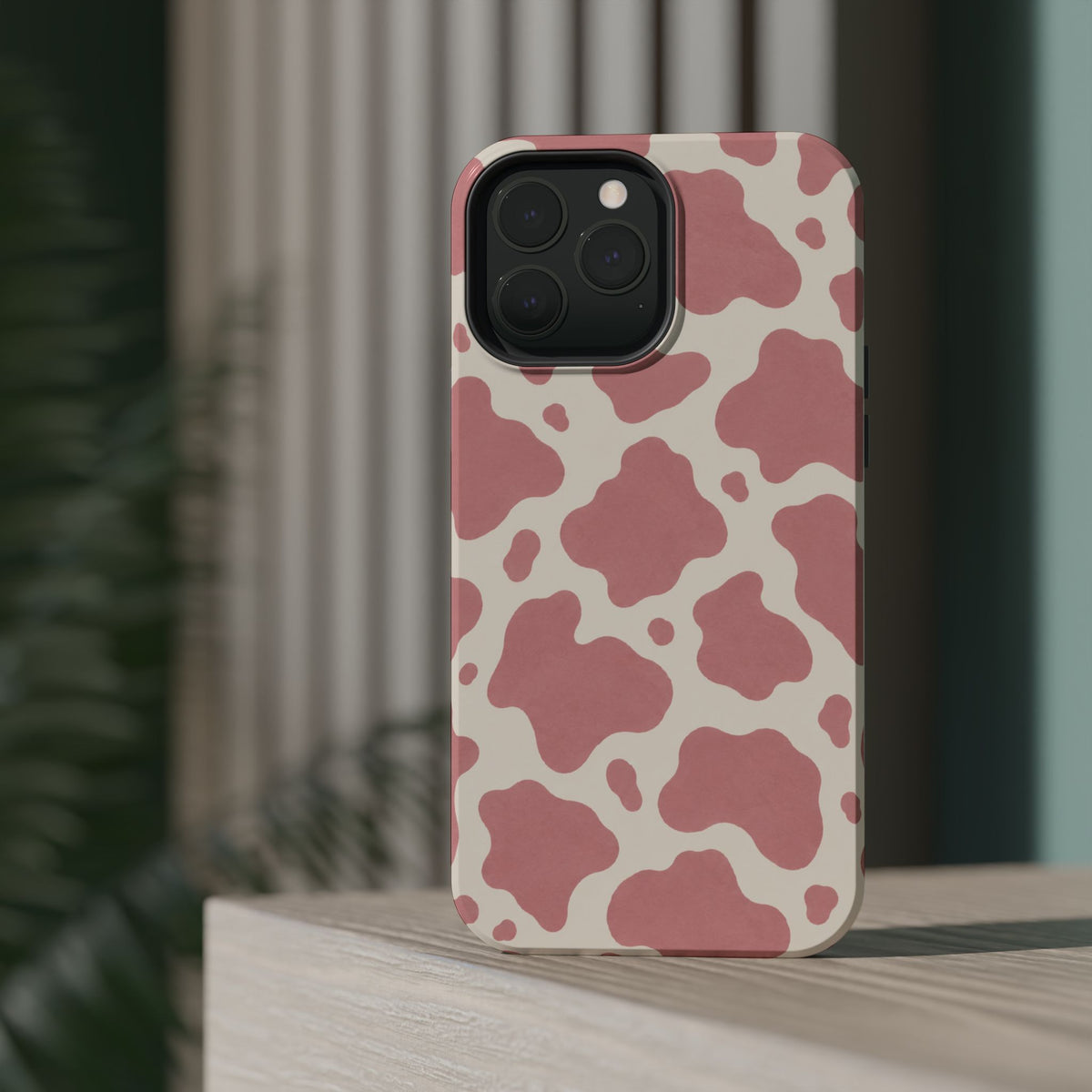 Rose Cowprint – Pink Cow Print MagSafe Phone Case, glossy square triple-camera Pro model, rear view on a tabletop