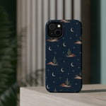 Desert Moon MagSafe Phone Case, glossy diagonal dual-camera model, rear view on a tabletop