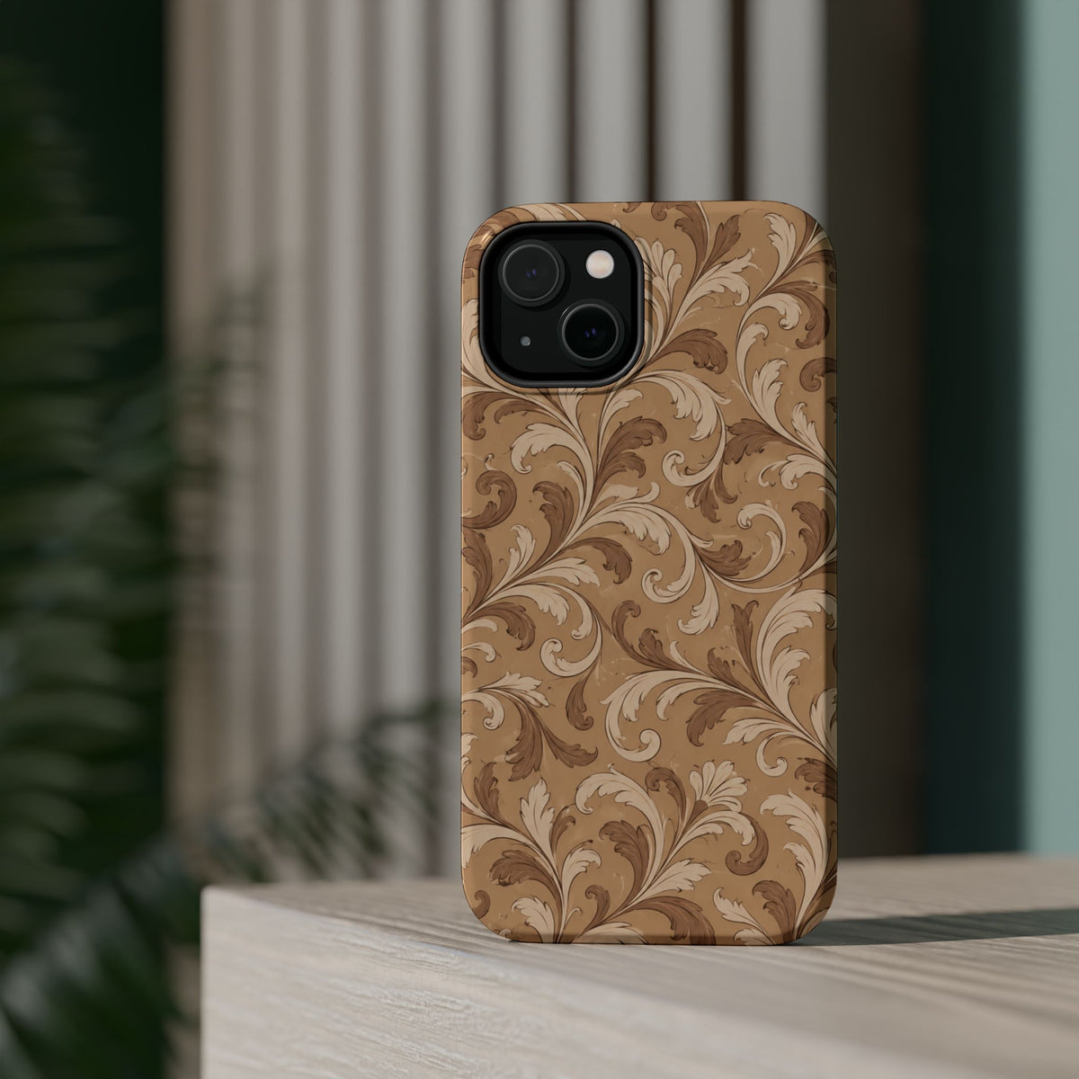Saddle Scrolls – Tan Western Scrollwork MagSafe Phone Case, glossy diagonal dual-camera model, rear view on a tabletop
