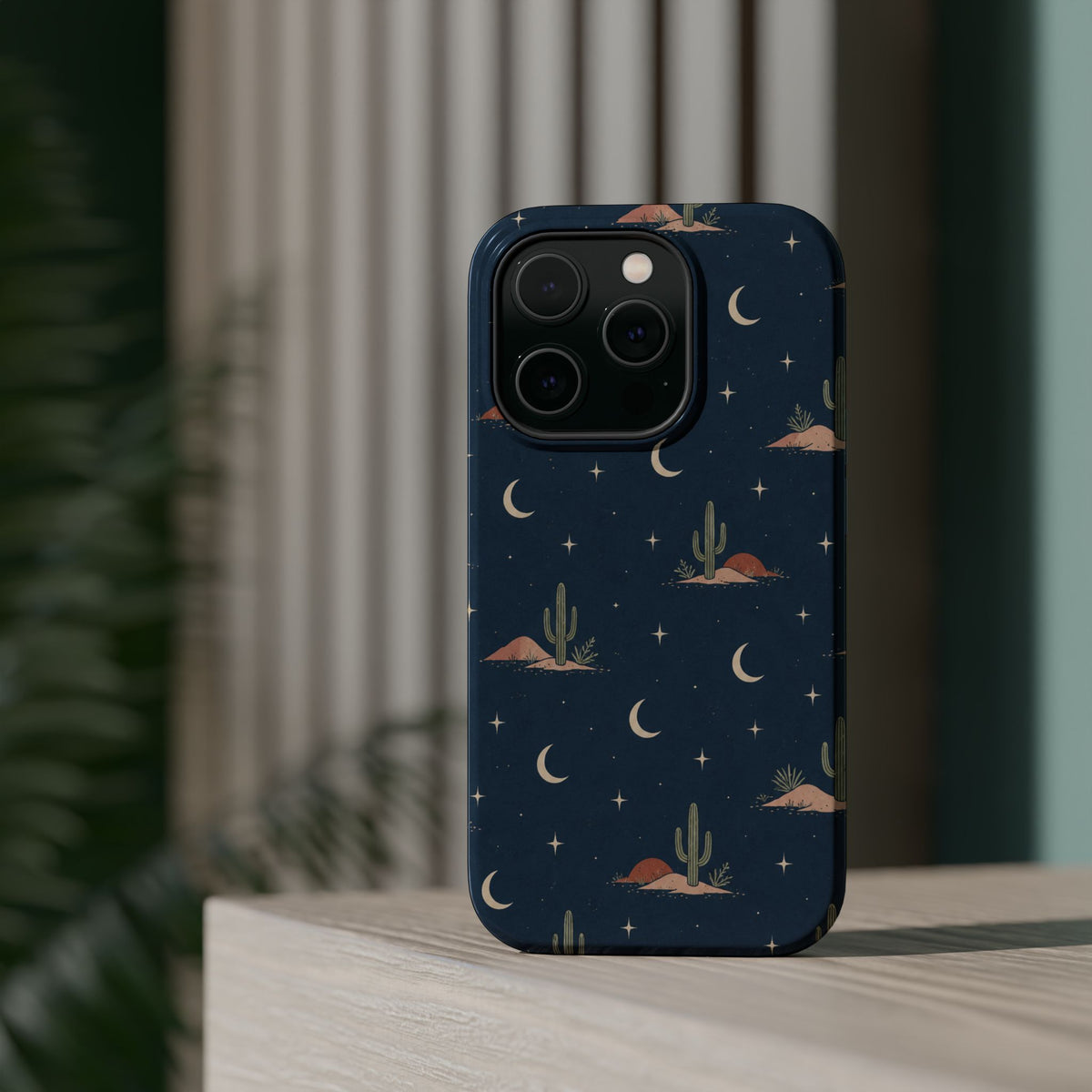 Desert Moon MagSafe Phone Case, glossy square triple-camera Pro model, rear view on a tabletop