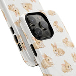 Close-up of two white iPhone cases featuring a cute brown bunny pattern in two different sizes