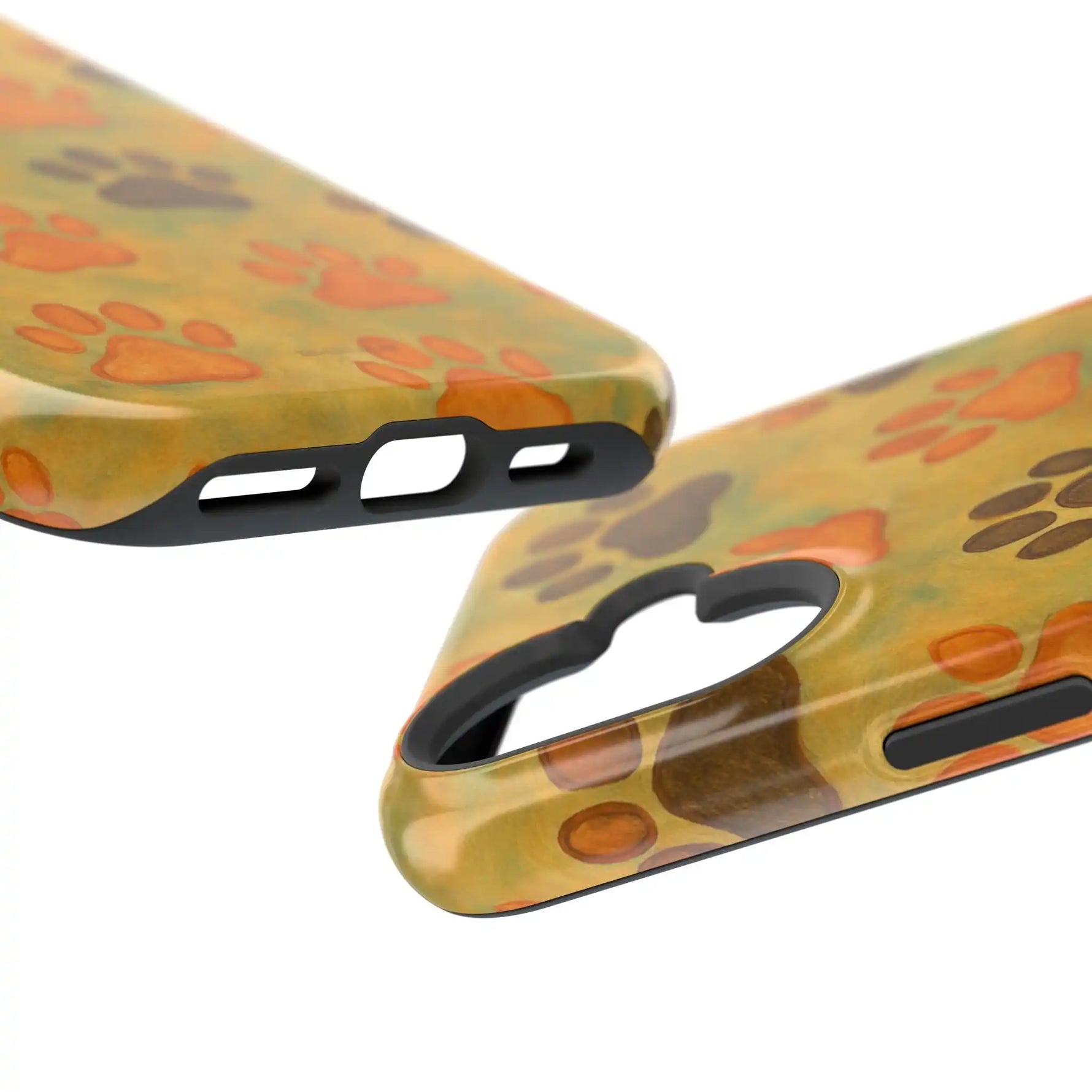 Close-up of glossy phone cases with orange and brown paw print patterns, showing size variant