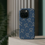 Lasso Hearts – Blue Western Heart MagSafe Phone Case, glossy square triple-camera Pro model, rear view on a tabletop