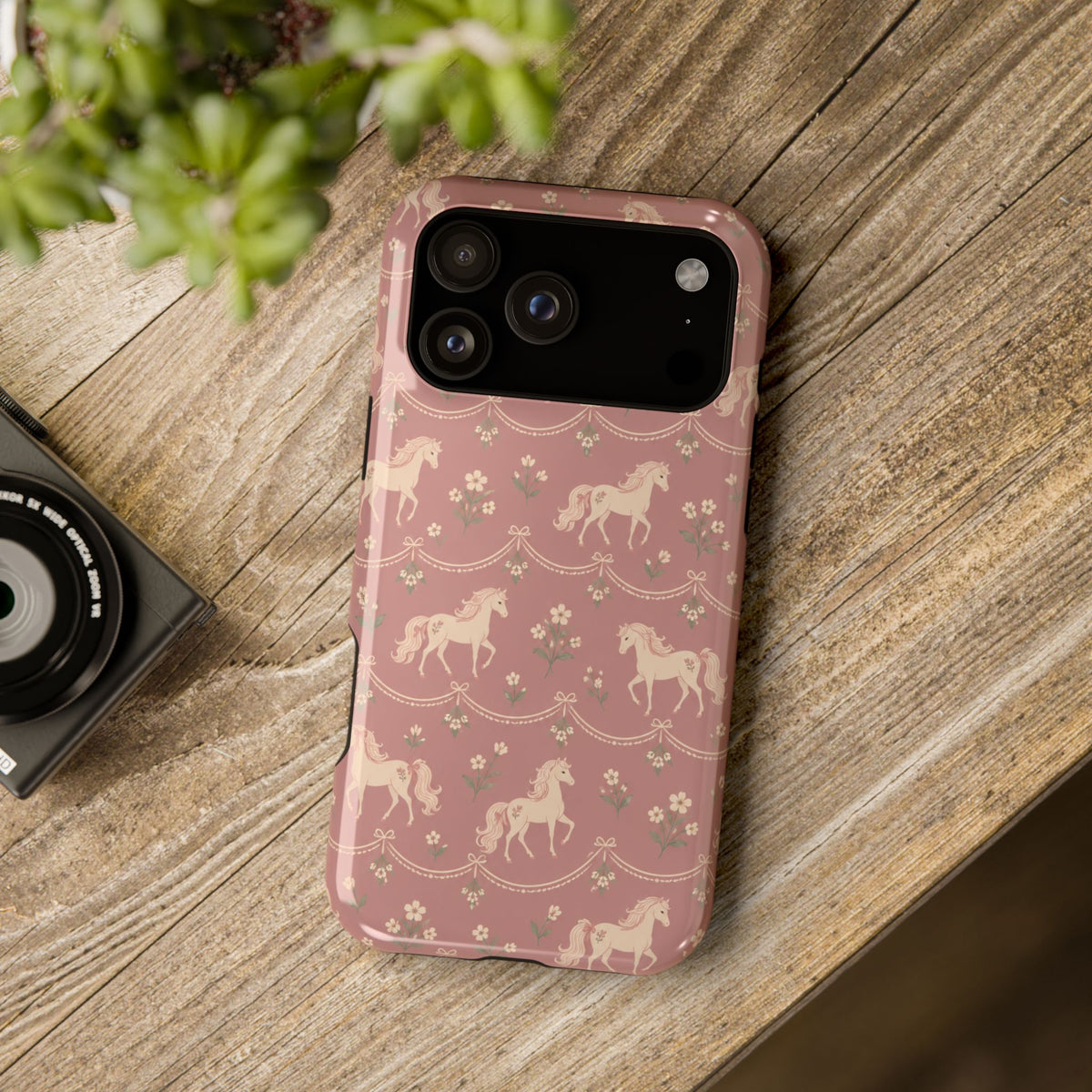 Rose Ponies MagSafe Phone Case, glossy wide-camera Pro model, rear view on a wooden surface