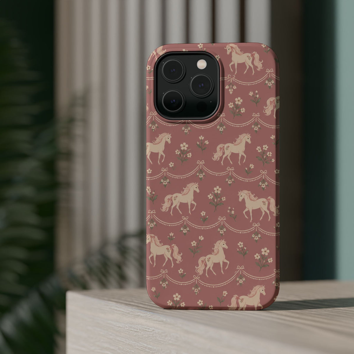 Rose Ponies MagSafe Phone Case, glossy square triple-camera Pro model, rear view on a tabletop