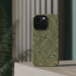 Golden Meadow – Sage Green Wildflower MagSafe Phone Case, glossy square triple-camera Pro model, rear view on a tabletop