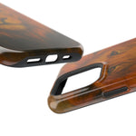 Close-up of two brown wood grain phone cases with cutouts for buttons and camera, showing variant size