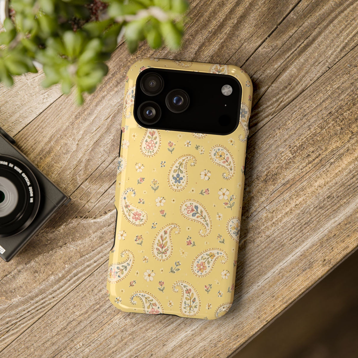 Honey Paisley MagSafe Phone Case, glossy wide-camera Pro Max model, rear view on a wooden surface