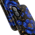 Close-up of two glossy phone cases with large blue floral patterns and gold leaf accents, showing different sizes