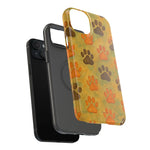 Black smartphone with two size variants of protective cases, one solid black and one with orange and brown paw prints