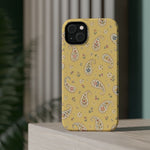 Honey Paisley MagSafe Phone Case, glossy diagonal dual-camera model, rear view on a tabletop