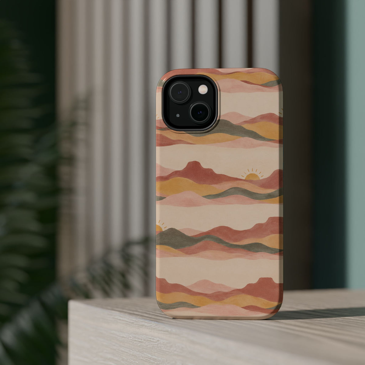 Sunset Trails – Desert Landscape MagSafe Phone Case, glossy diagonal dual-camera model, rear view on a tabletop