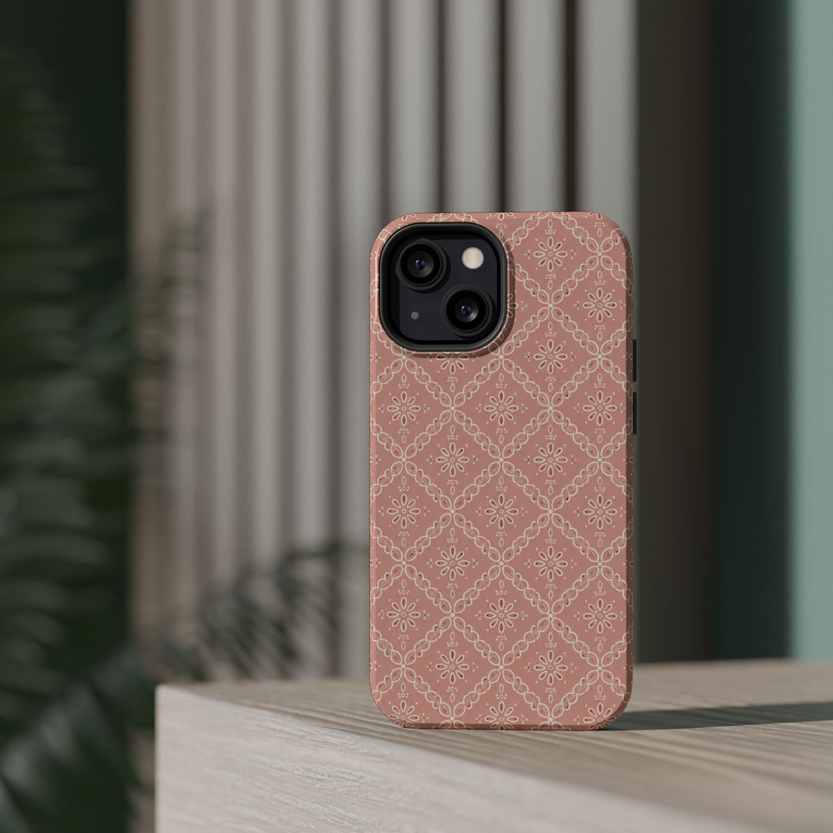 Meadow Lace – Blush Pink Lace Pattern MagSafe Phone Case, glossy diagonal dual-camera model, rear view on a tabletop
