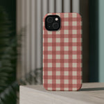 Prairie Gingham MagSafe Phone Case, glossy diagonal dual-camera model, rear view on a tabletop