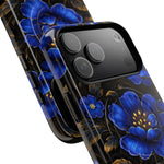 Two iPhones with glossy black cases featuring vibrant blue floral designs and gold accents, showing camera details and variant size