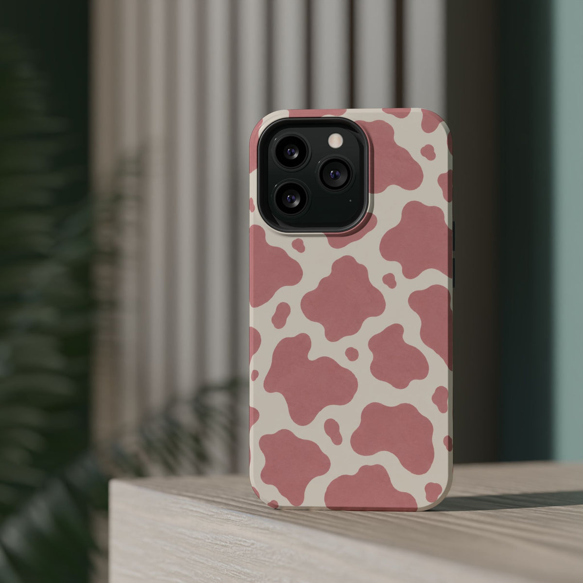 Rose Cowprint – Pink Cow Print MagSafe Phone Case, glossy square triple-camera Pro model, rear view on a tabletop