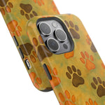Two sizes of yellow phone cases with orange and brown paw print pattern for iPhone cameras