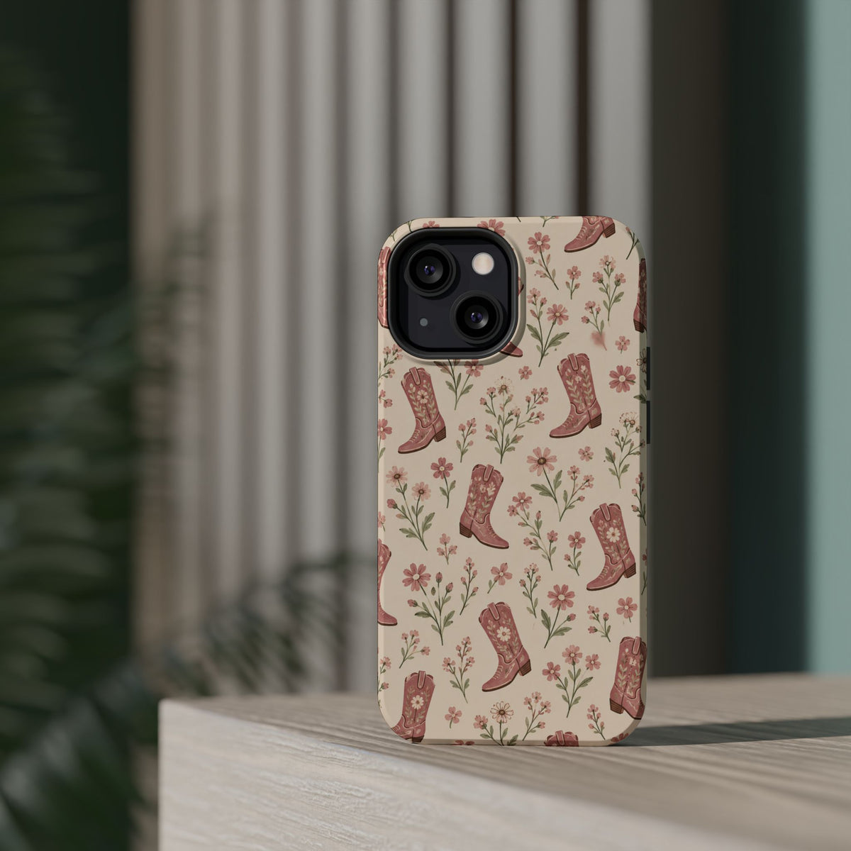 Floral Boots MagSafe Phone Case, glossy diagonal dual-camera model, rear view on a tabletop