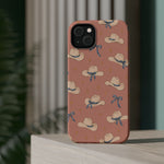Ribbon Rodeo – Cowgirl Hat and Bow MagSafe Phone Case, Pink, glossy diagonal dual-camera model, rear view on a tabletop