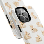 Two white phone cases with cute beige bunny pattern, showing variant size with Triple camera cutout