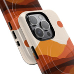 Two smartphone cases with abstract orange mountain designs and black buttons, showing different sizes