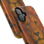 Close-up of two smartphone cases with detailed lion face design, showing different sizes