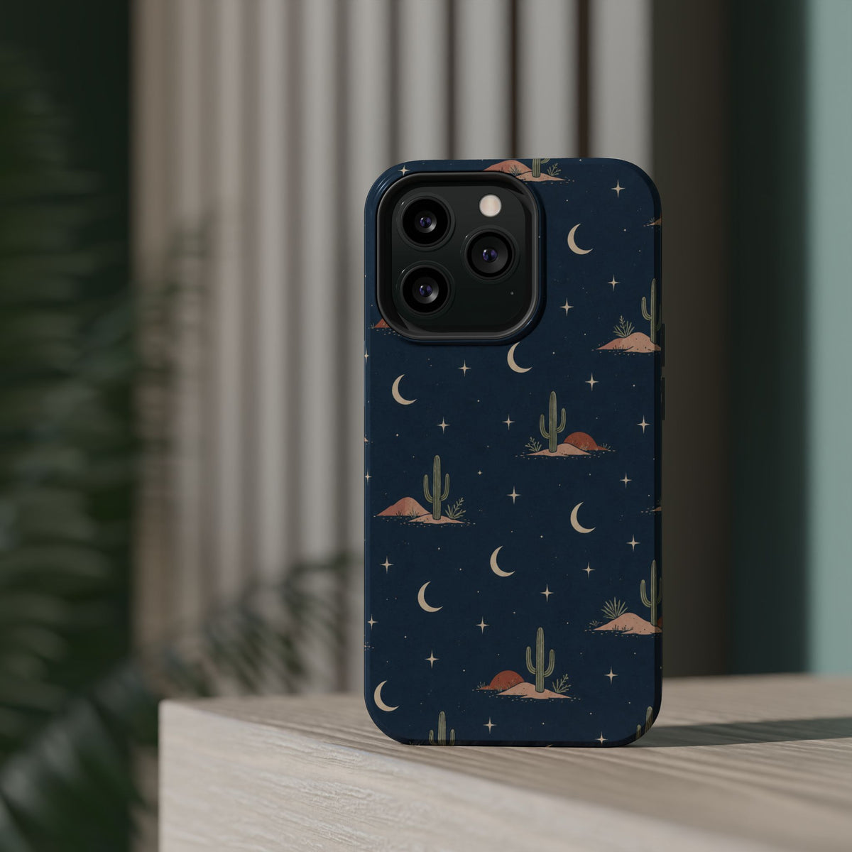 Desert Moon MagSafe Phone Case, glossy square triple-camera Pro model, rear view on a tabletop