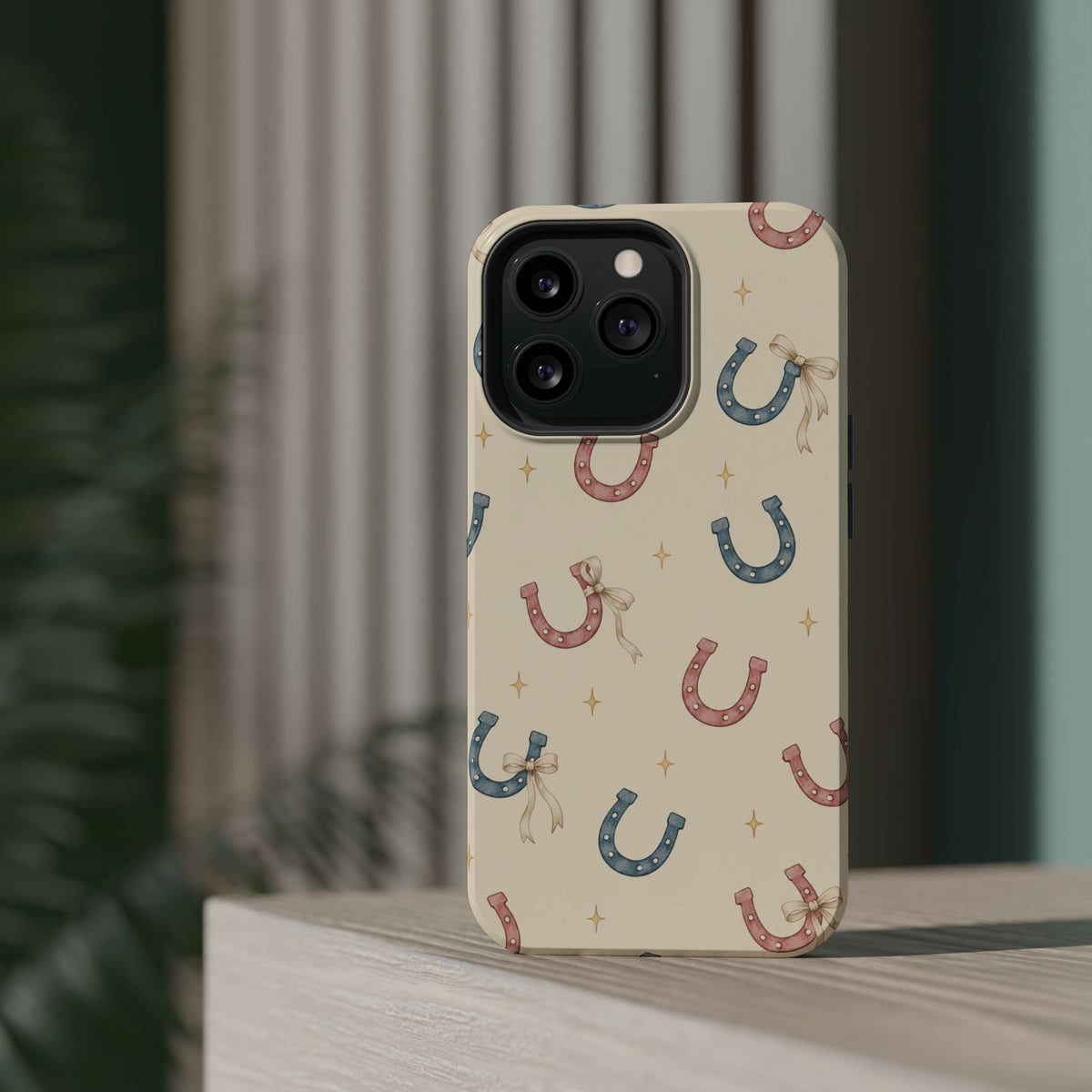 Prairie Horseshoes MagSafe Phone Case, glossy square triple-camera Pro model, rear view on a tabletop