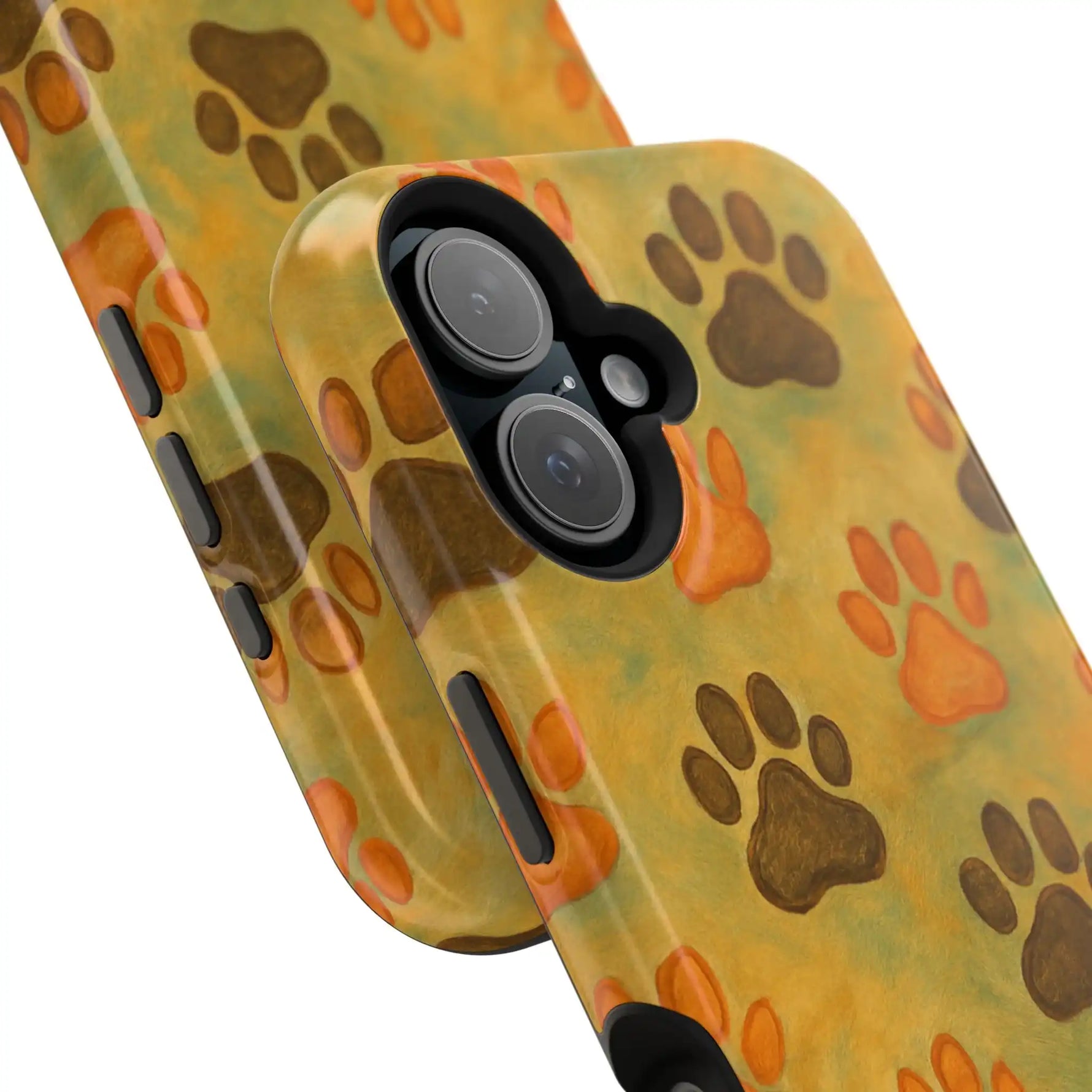 Close-up of two phone cases in different sizes with orange and brown paw print design on yellow background
