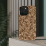 Saddle Scrolls – Tan Western Scrollwork MagSafe Phone Case, glossy square triple-camera Pro model, rear view on a tabletop
