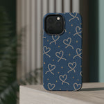 Lasso Hearts – Blue Western Heart MagSafe Phone Case, glossy square triple-camera Pro model, rear view on a tabletop