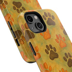 Close-up of two size variants of yellow phone cases with brown and orange paw print pattern