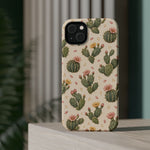 Cactus Bloom – Sage Green Floral Cactus MagSafe Phone Case, glossy diagonal dual-camera model, rear view on a tabletop