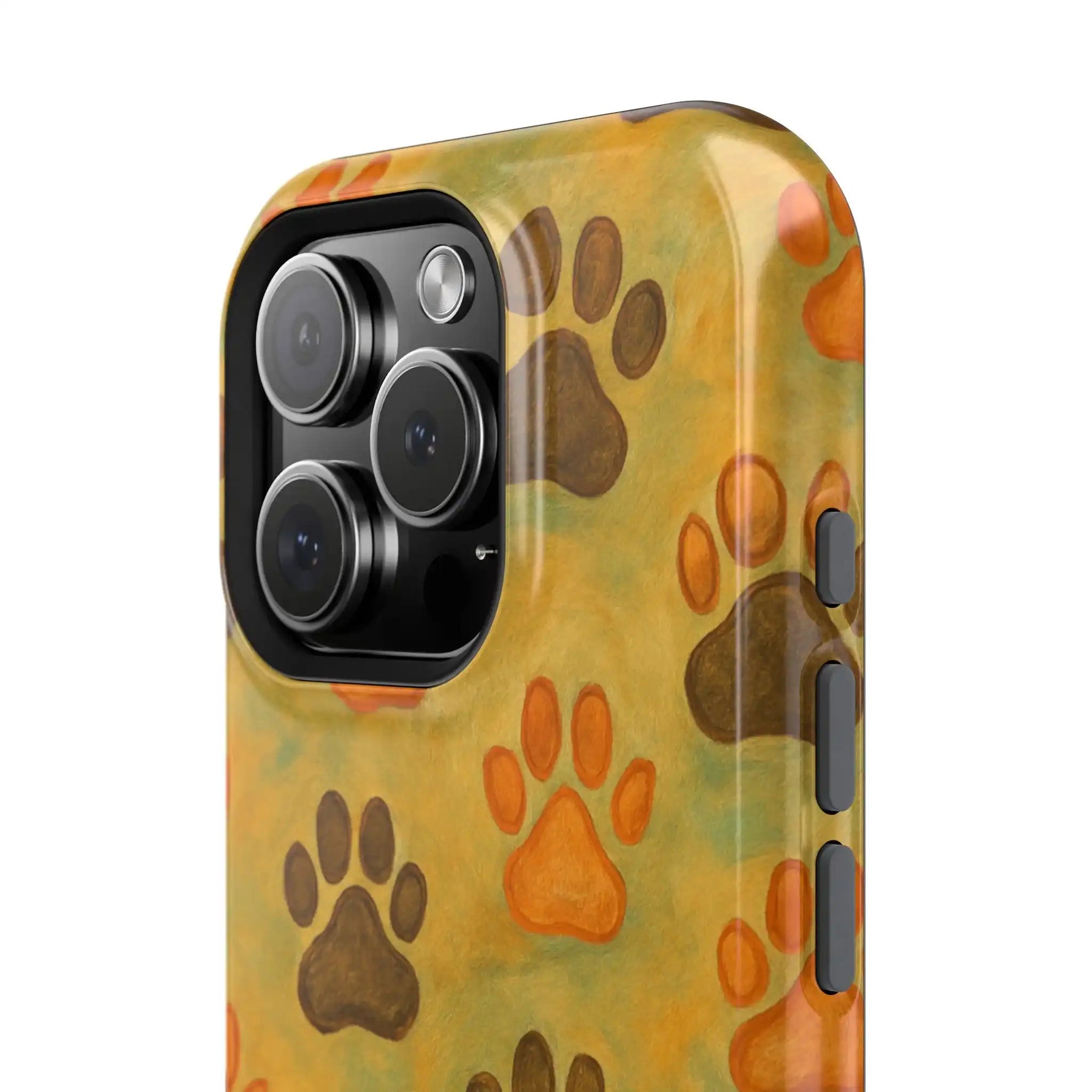 Close-up of phone case with large camera cutout, featuring brown and orange paw print pattern on mustard background